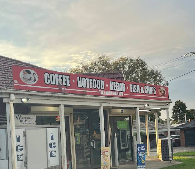 McCormicks Food Store exterior with red signage, glass doors and covered canopy