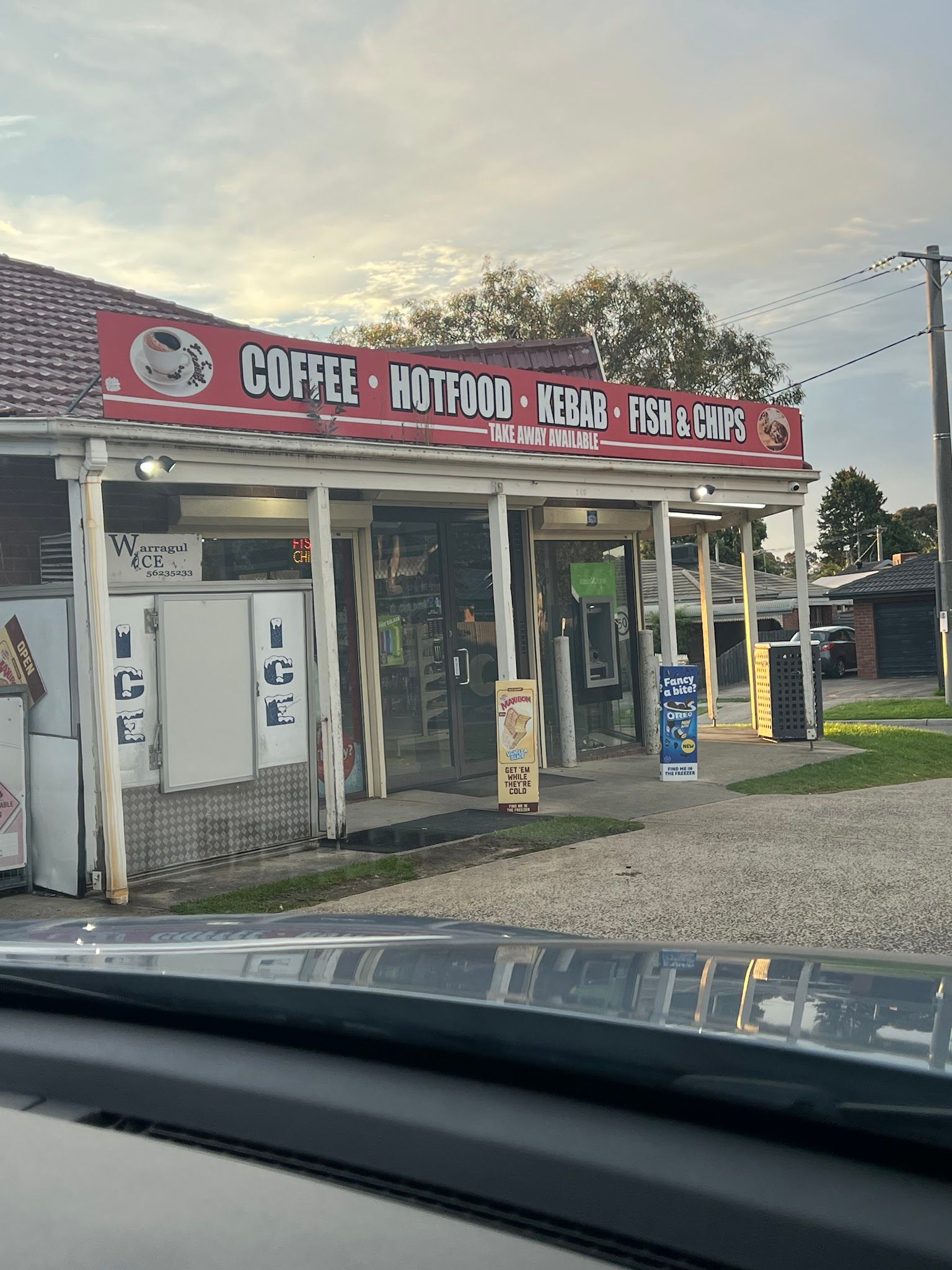 McCormicks Food Store exterior shot from inside a car, red signage visible